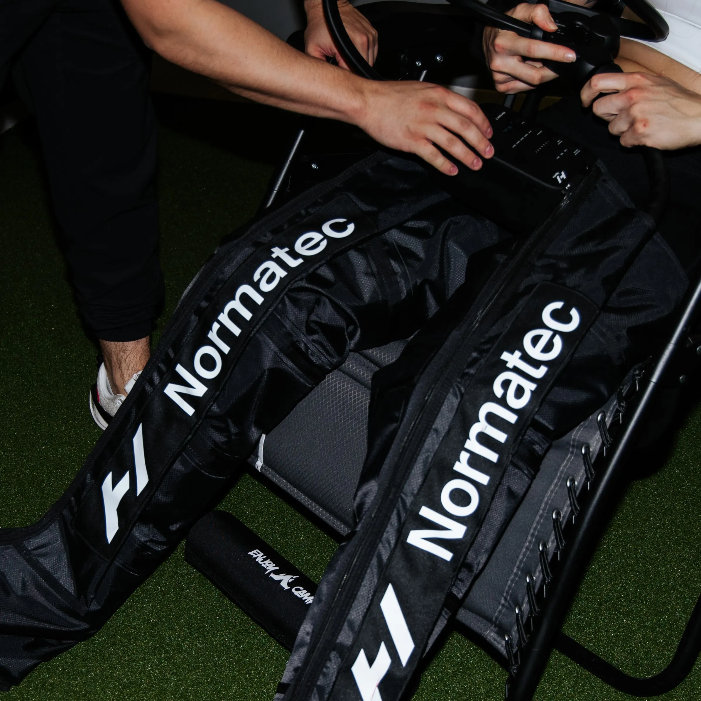 A client relaxes while receiving compression therapy withy Normatec boots.