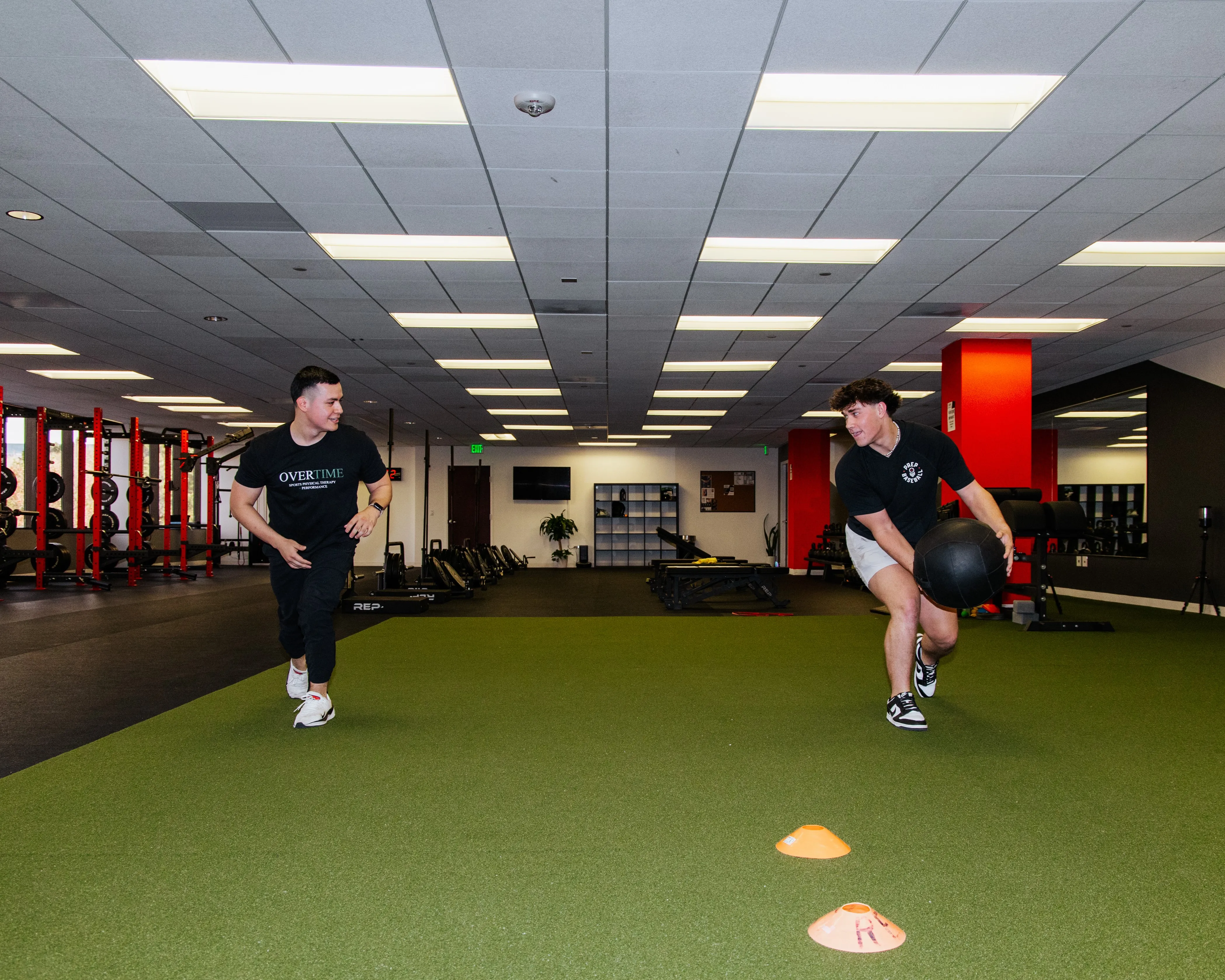 Dr. Benitez works in the OVERTIME Sports gym to improve a client's performance levels.